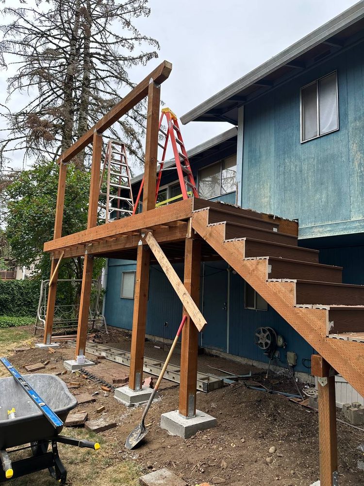Post and beam framing for an elevated deck with stair stringers in place