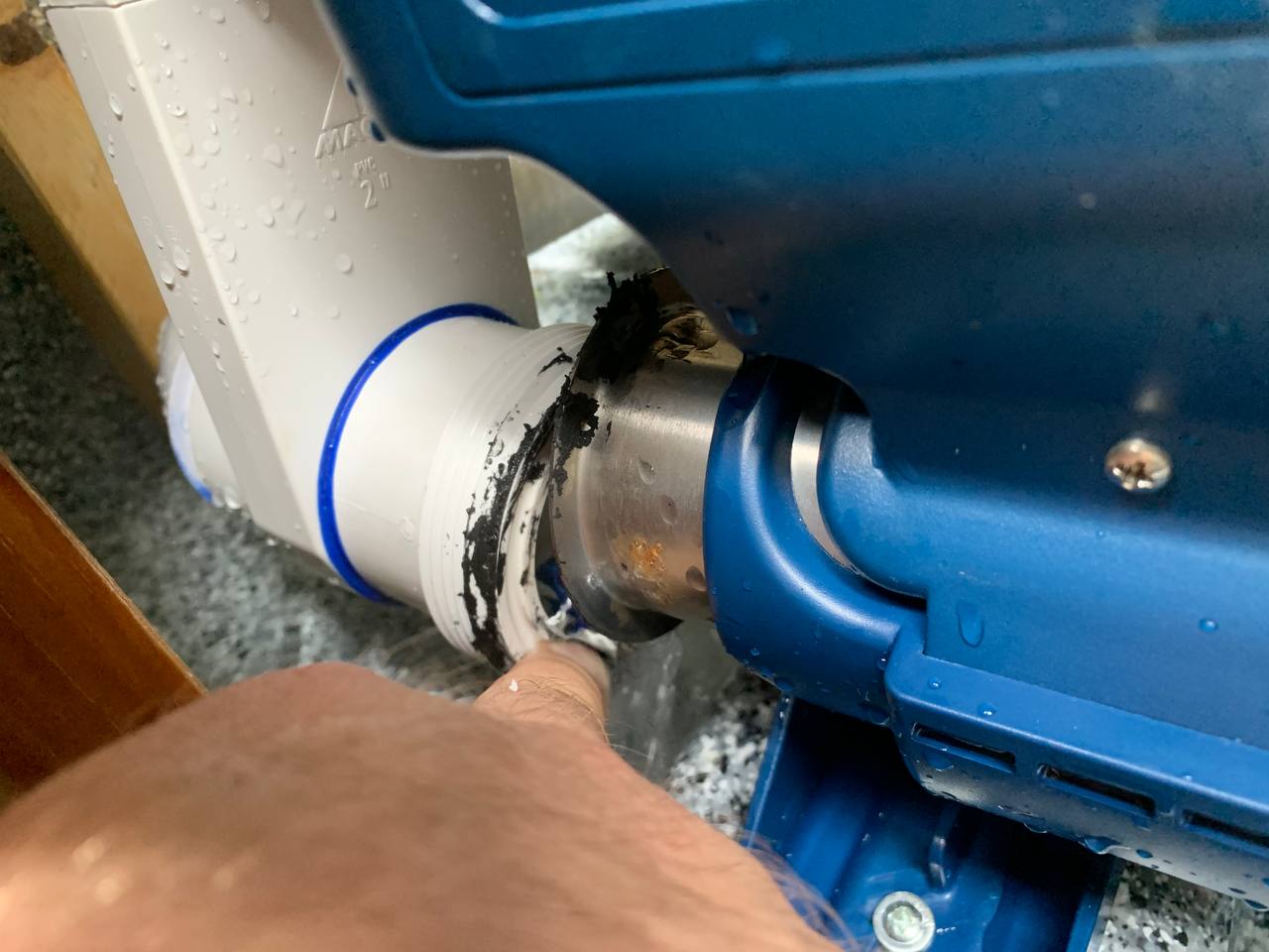 Hands removing a leaking union from a spa heater assembly