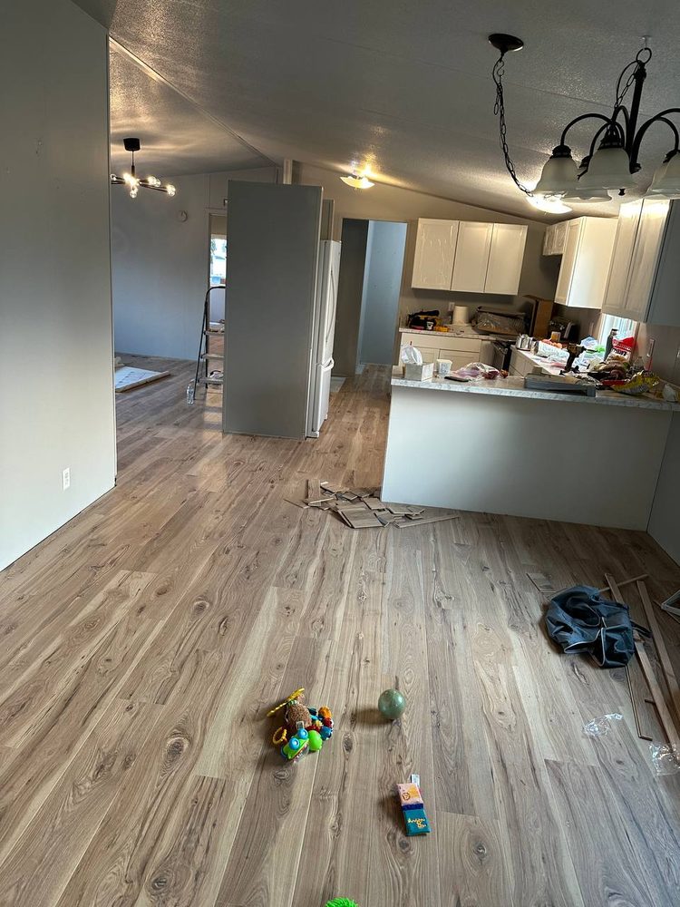 Luxury vinyl plank flooring run through a living room and into the kitchen