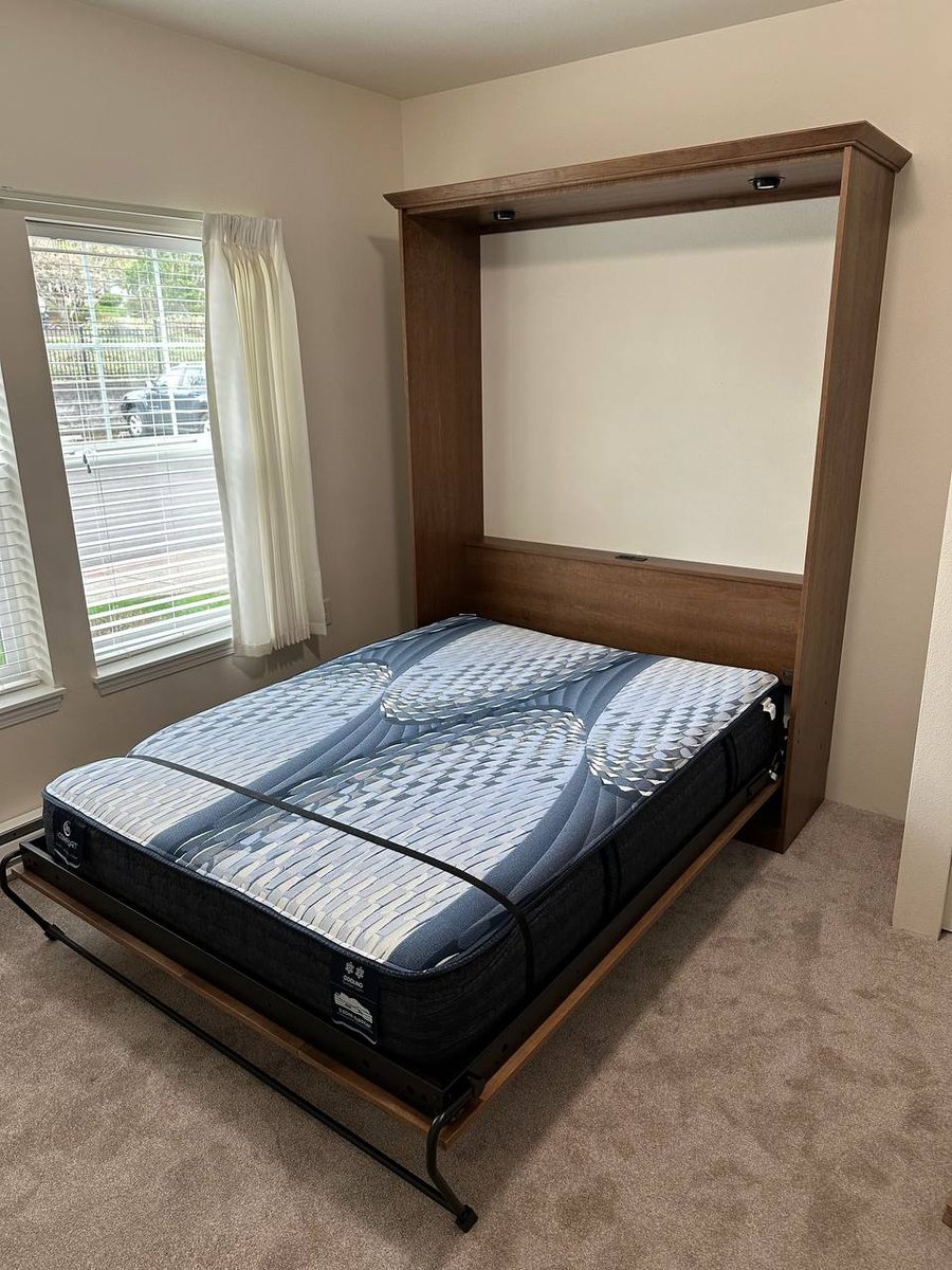 Assembled murphy bed folded down with the mattress in place