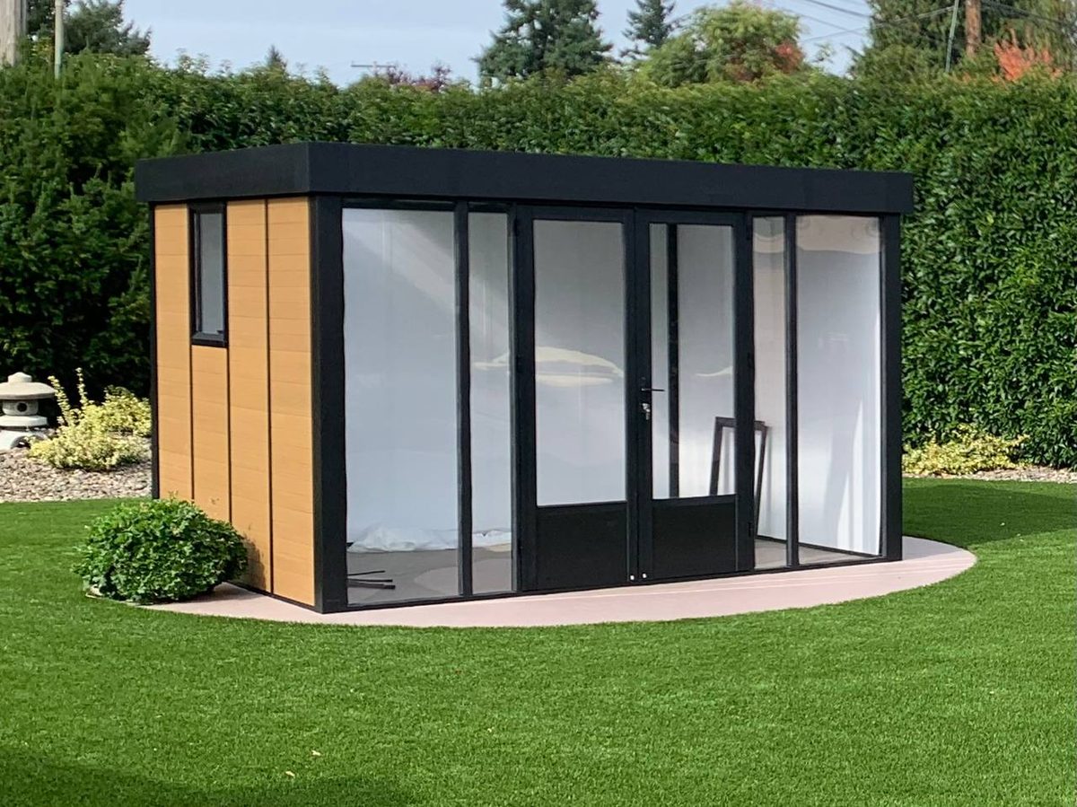Finished modular backyard studio with glass sliding doors beside the pool