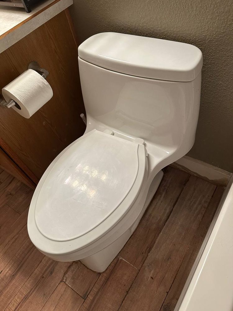 New one-piece toilet set and sealed in a small bathroom
