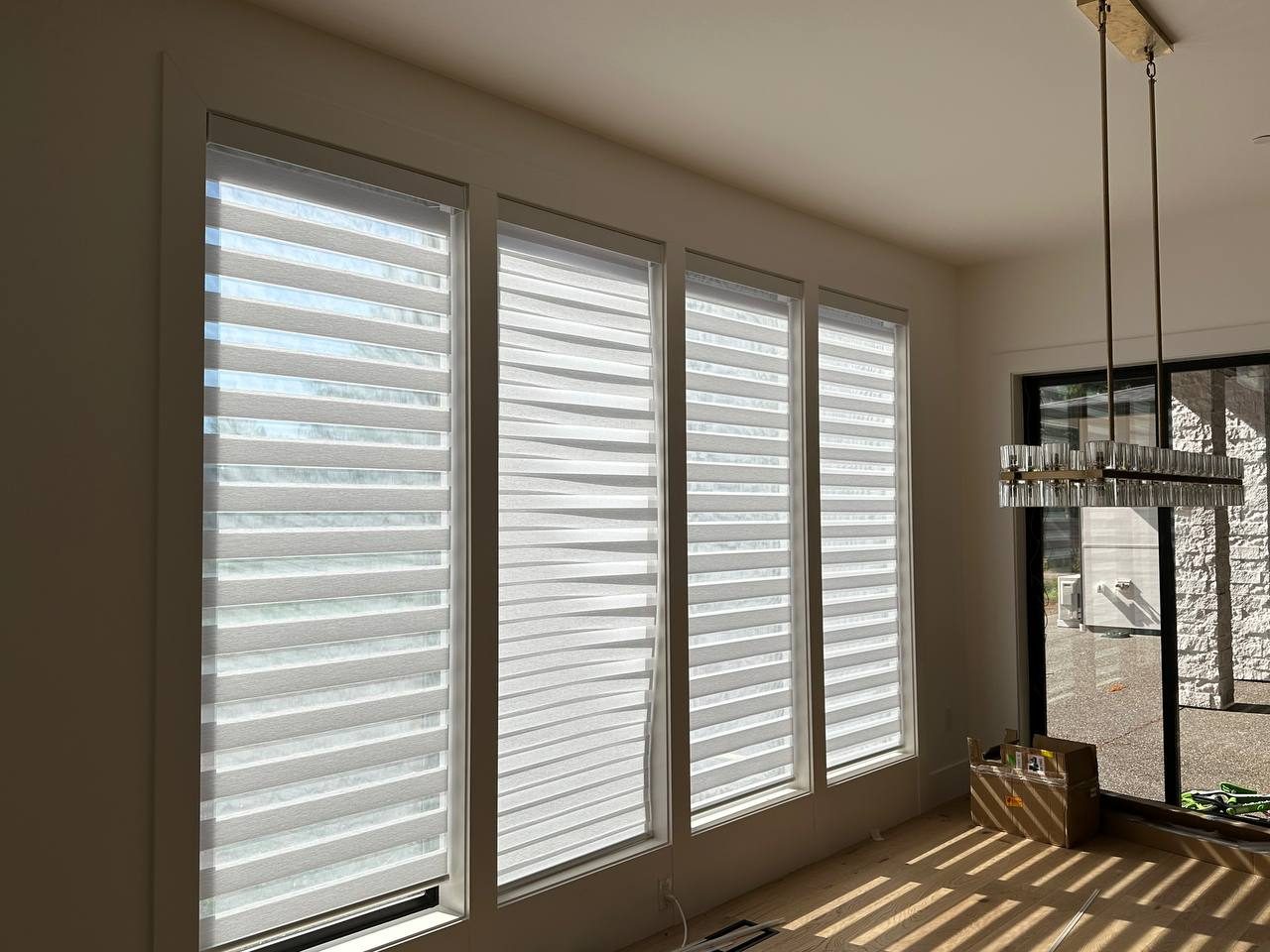 Window shades installed across a bank of living room windows